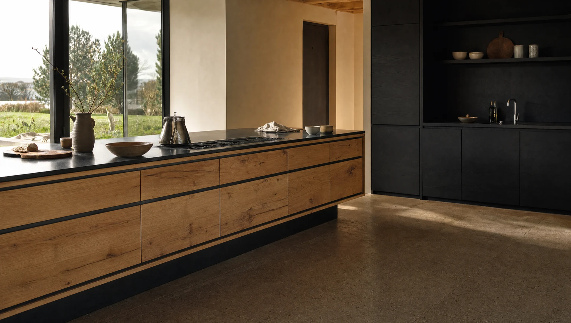 The oak drawer run under the dark countertop, with the room behind it