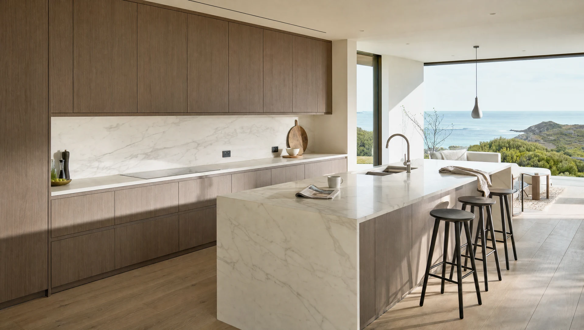 The same range in a lighter setting, a pale island with stools and the sea beyond