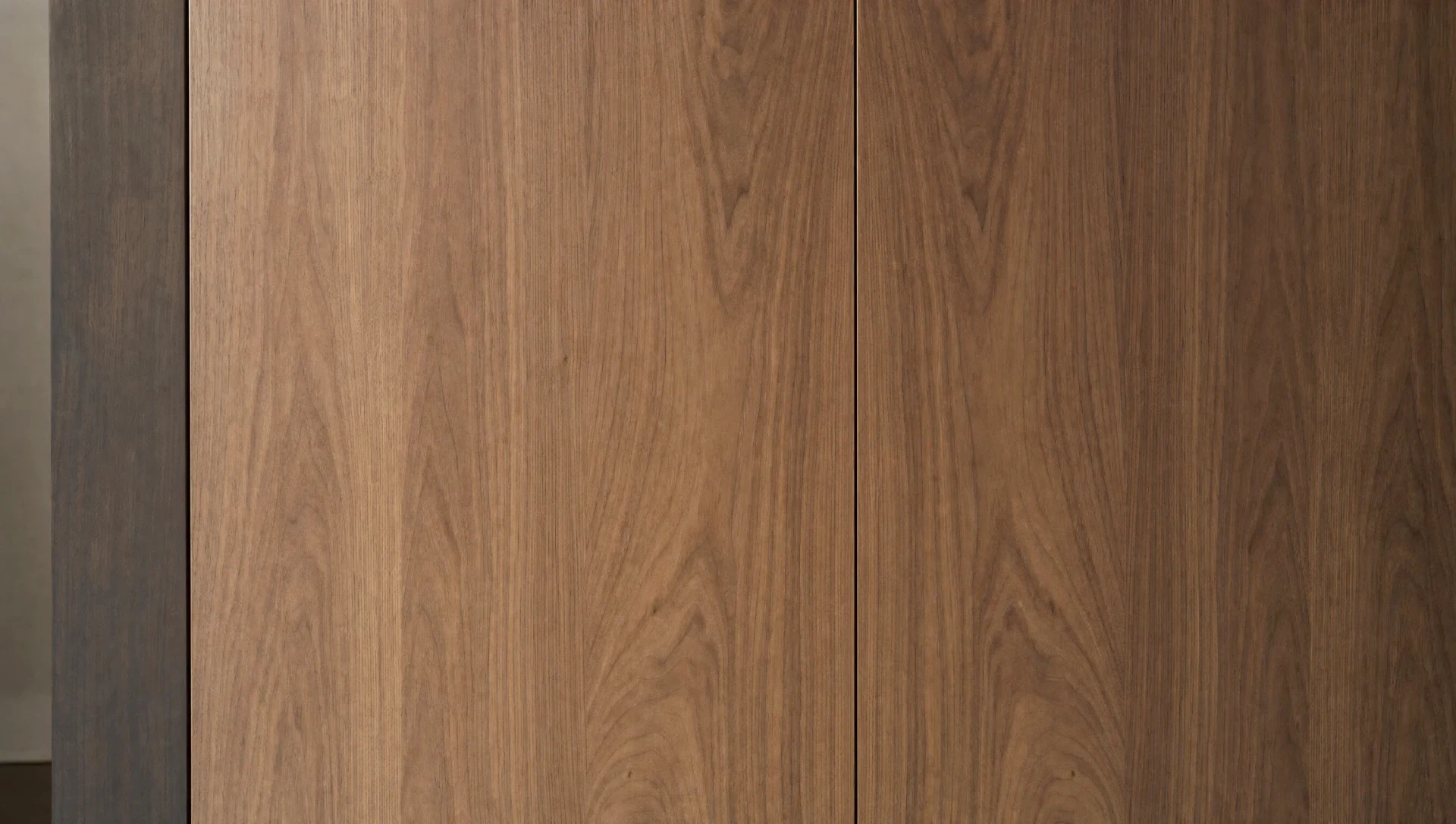 Detail of a sprayed handleless front in book-matched veneer, The Kensington range by Square & True