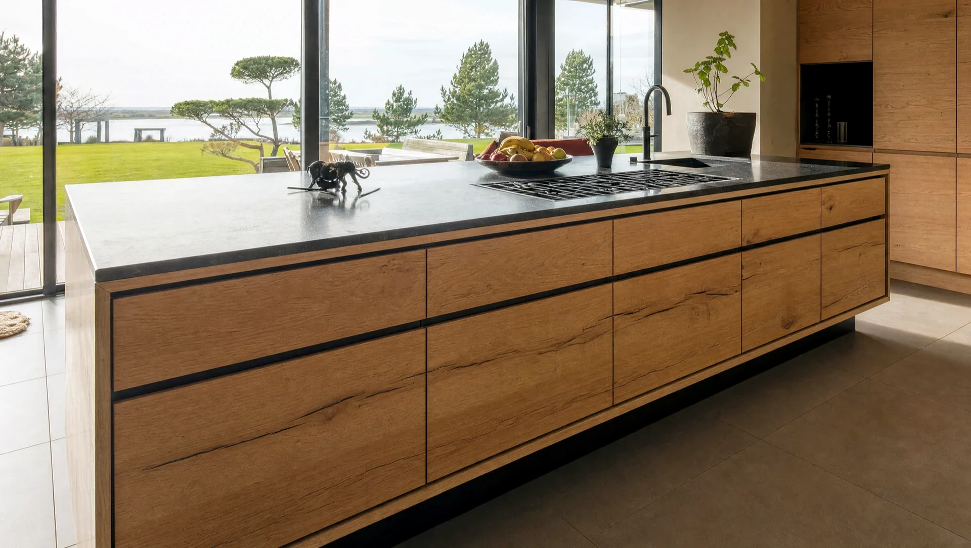 The sink run in matt black, the oak island in front of it