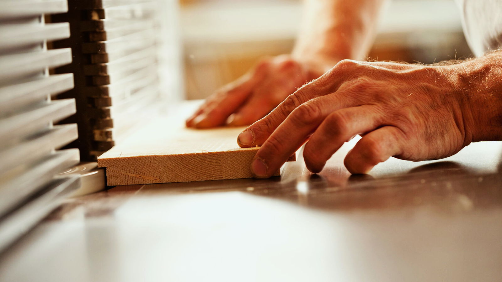 A cabinetmaker’s hands at work on the bench.